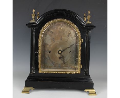 A late Victorian ebonized and brass mounted bracket clock with eight day triple fusee movement chiming quarters on a nest of 