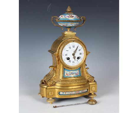 A mid-19th century French ormolu and porcelain mounted mantel clock with eight day movement striking on a bell via an outside