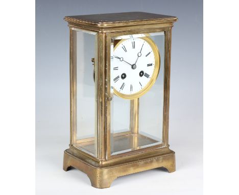 An early 20th century French brass cased four glass mantel clock with eight day movement striking on a bell, the circular ena