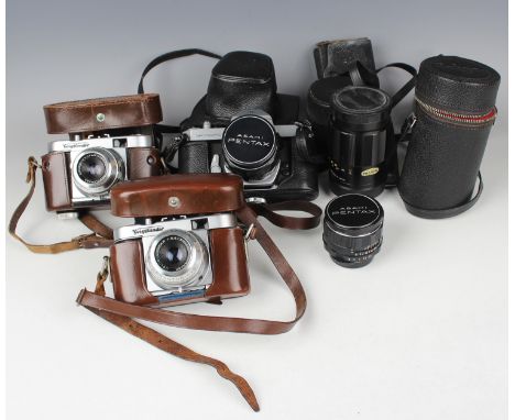 A collection of cameras and accessories, including two Voigtländer Vito B cameras, a Pentax Spotmatic camera with Takumar 1:1