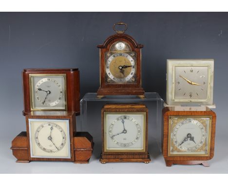 A group of six Elliott clock mantel timepieces, each with signed dial, in various cases including walnut, mahogany, oak and o