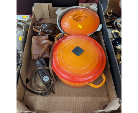 A Le Creuset orange enamelled pot, together with another similar, and three vintage cameras 