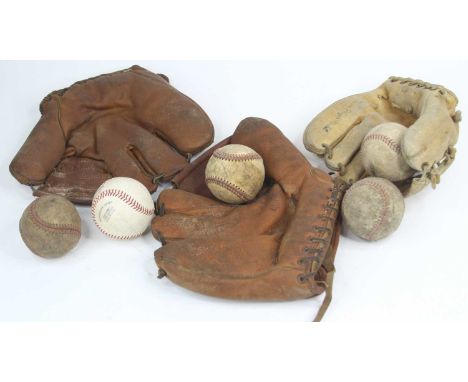 A collection of vintage baseball balls and gloves