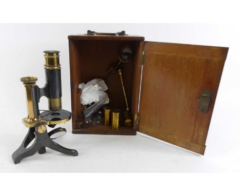 A brass monocular microscope, stamped J White Glasgow to the base, cased with accessories 