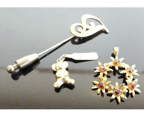 A yellow metal garnet set flower head pendant, unmarked but tests as approx 9ct gold, 2.9g, dia.25mm; together with a hollow 