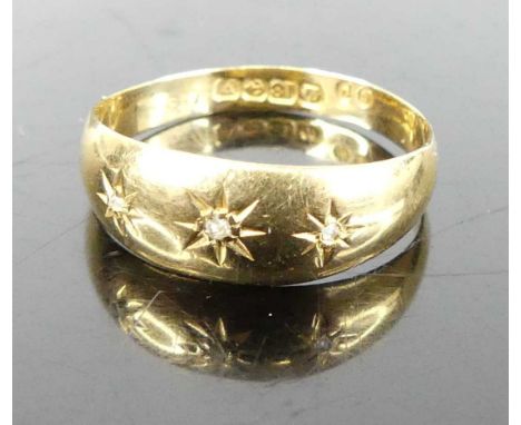 An 18ct gold band ring, 'gypsy' set with three diamond points, 2.1g, size P 
