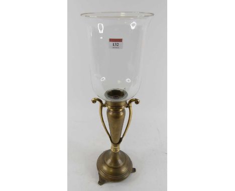 A brass table candlestick, having a clear glass shade, h.60cm 