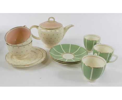 A Susie Cooper part tea service on a cream ground with pink star decoration, printed mark verso, numbered 1687, together with