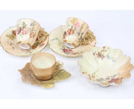 A pair of Royal Worcester blush ivory 1334 pattern coffee cans and saucers, decorated with flowers; together with another Roy