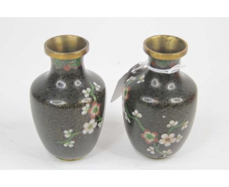A pair of small Chinese cloisonne enamel vases, each decorated with flowers, h.10cm 