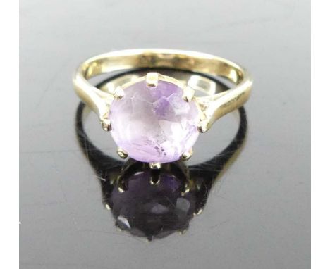 A yellow metal and round cut amethyst set dress ring, unmarked but tests as approx 9ct gold, 2.2g, size L