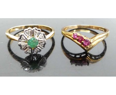 An 18ct gold, emerald and diamond point set flower head cluster ring, 3g, size O; together with a 9ct gold ruby set wishbone 