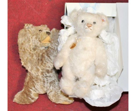 A Steiff white mohair teddy-bear, having glass eyes and opposable limbs, boxed; together with a blond mohair teddy-bear (2)