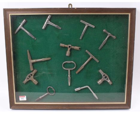 A framed and glazed display of various vintage mixed region railway carriage keys to include LNWR, SAR, GNR, GER, LNER, and v