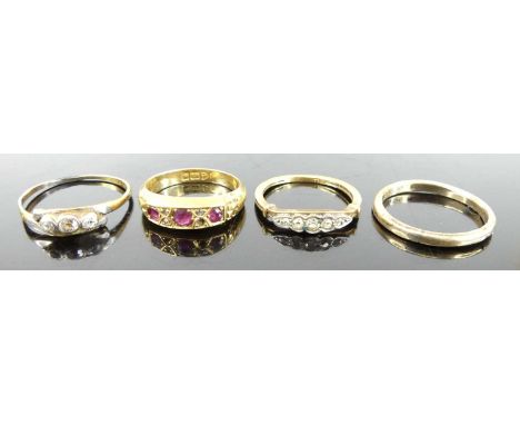 An 18ct gold, ruby and diamond point set half hoop ring; together with two 9ct gold diamond point set dress rings; and a yell