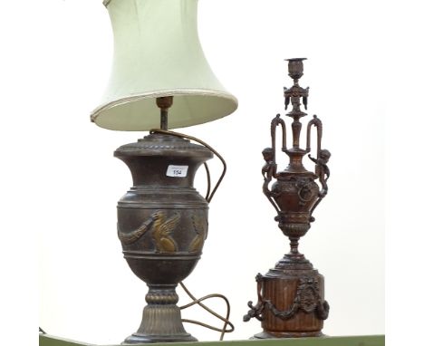 A brass table lamp with griffon decoration, and a candlestick with cherub figures, 56cm 