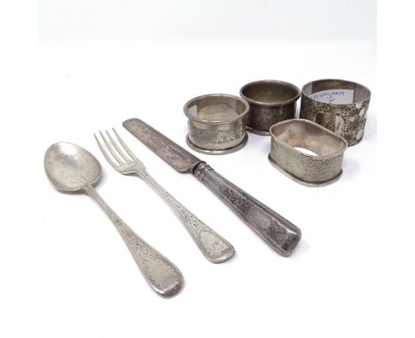 4 silver napkin rings, an engraved silver fork and spoon and knife set 