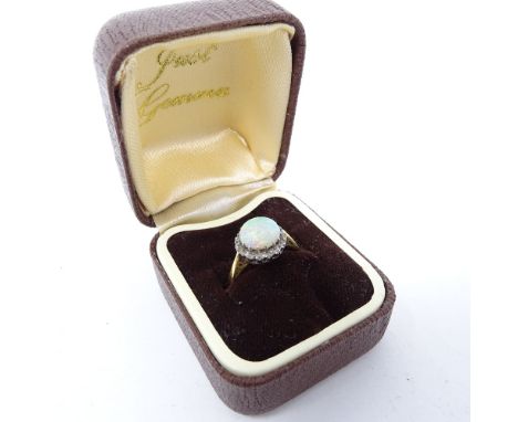 An 18ct gold opal ring, with white stone band, size K 