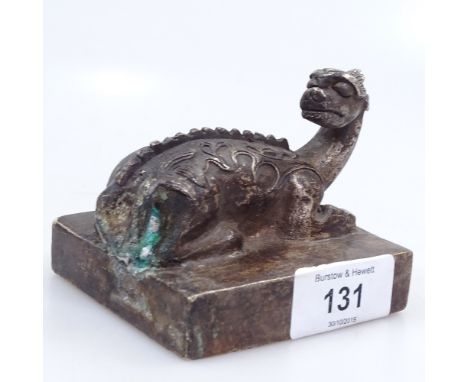 A Chinese metal seal surmounted by a mythical beast, length 8cm 