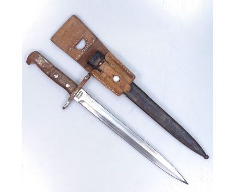 A German First War rifle bayonet and scabbard, stamped Waffenfabrik Neuhausen, no. 16075, blade length 30cm 