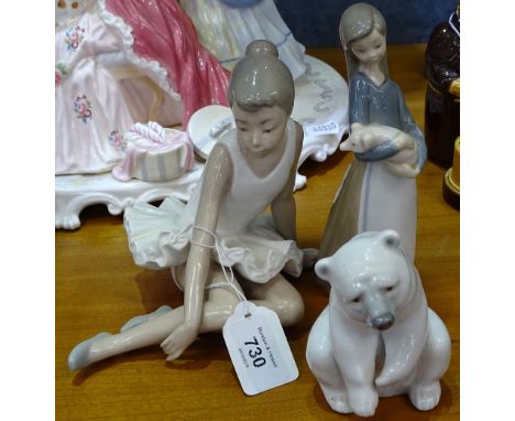 A Lladro figure, girl holding a piglet, a NAO figure ballerina, and a Lladro figure polar bear 