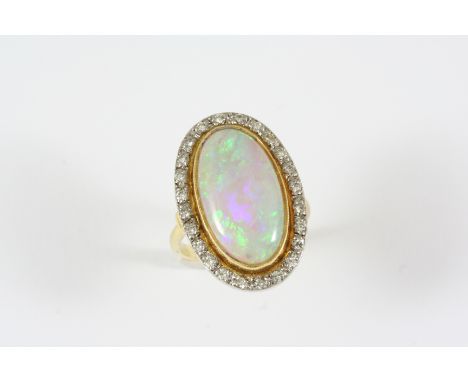 AN OPAL AND DIAMOND CLUSTER RING the oval-shaped solid white opal is set within a surround of circular-cut diamonds, in 18ct.