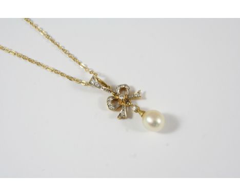 A DIAMOND AND CULTURED PEARL PENDANT the 18ct. gold bow diamond set pendant suspends a cultured pearl drop, 4cm. long, on an 