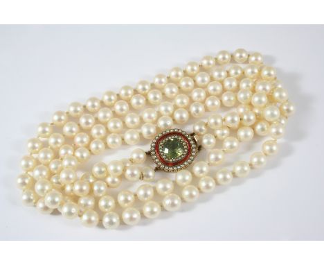 A TWO ROW UNIFORM CULTURED PEARL NECKLACE the pearls measure approximately 8.5mm., and are set to an oval-shaped gold clasp, 