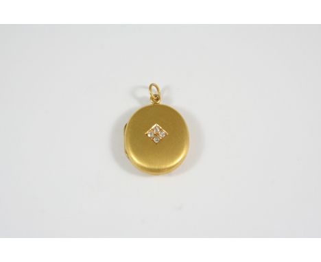 A DIAMOND AND 15CT. GOLD LOCKET PENDANT the oval-shaped locket is centred with four cushion-shaped diamonds, 2.5 x 2.0cm., 5.