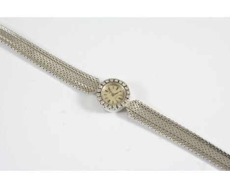 A LADY'S DIAMOND AND 18CT. WHITE GOLD WRISTWATCH BY OMEGA the signed circular dial with baton numerals, with circular single-