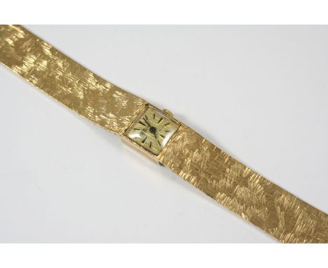 A LADY'S 9CT. GOLD WRISTWATCH BY BENSON, LONDON the signed square-shaped dial with dagger and baton numerals, on an integrate