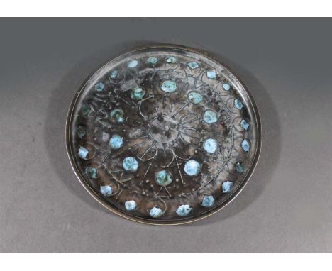 TROIKA CIRCULAR PLATE - TRIDENT MARK a circular plate with a floral design and black glazed ground. Impressed marks, Troika, 