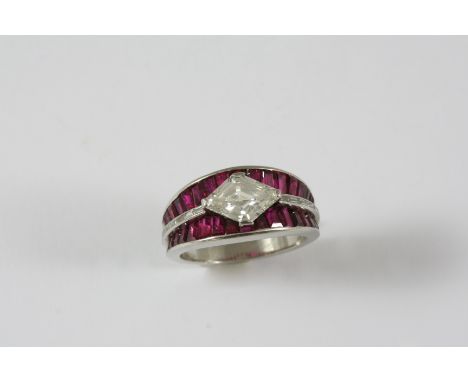 A RUBY AND DIAMOND RING the diamond-shaped diamond is set within a surround of calibre-cut rubies with a row of baguette-cut 