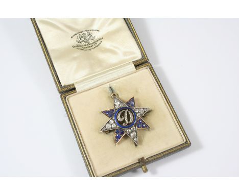 A SAPPHIRE AND DIAMOND STAR BROOCH PENDANT centred with a diamond set initial D, within a blue enamel surround, the rays alte