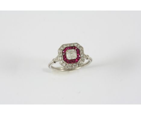 A RUBY AND DIAMOND CLUSTER RING the central square-shaped diamond is set within a surround of calibre-cut rubies and circular
