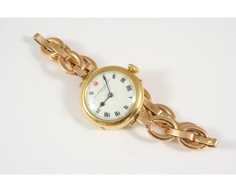 AN 18CT. GOLD WRISTWATCH BY SIR JOHN BENNETT LTD, LONDON the signed white enamel dial with one red and black Roman numerals, 