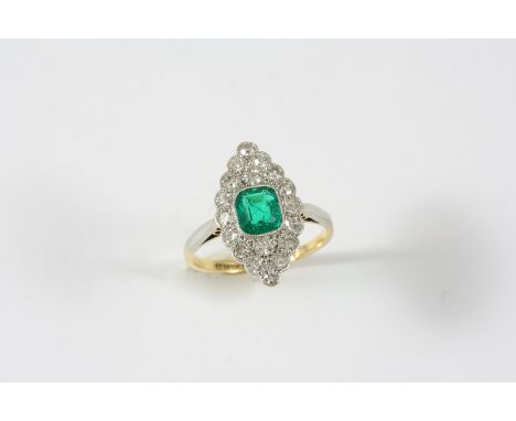 AN EMERALD AND DIAMOND MARQUISE-SHAPED CLUSTER RING the cushion-shaped emerald is set within a surround of single-cut diamond