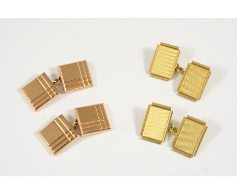 A PAIR OF 18CT. GOLD CUFFLINKS of rectangular shape with cut corners and engine turned decoration, hallmarked for London 1954