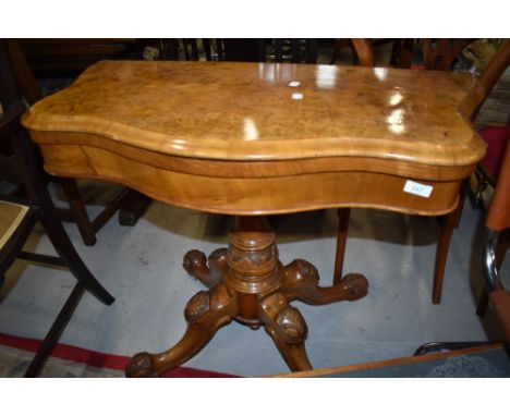 A fold out card table possibly late Victorian having carved base with Burr veneer decorated top