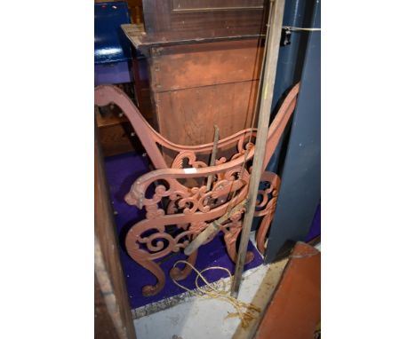 A pair of cast bench ends and a tree lopper