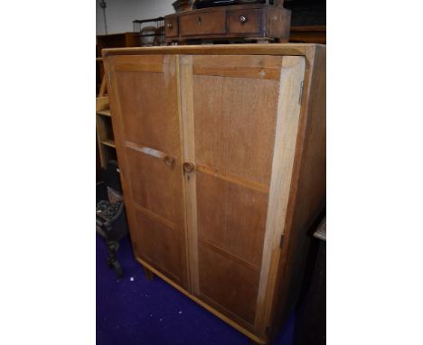 A vintage golden oak compact wardrobe, part fitted interior, height approx. 123cm, width 84cm
