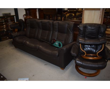 A modern Stressless three seater sofa settee and two arm chairs with foot stools in good condition throughout, some wear but 