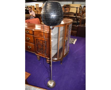 A modern standard lamp having basket style shade