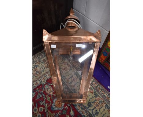 A Copper wall light in the Victorian street lamp style, having cast wall mountings, perspex panes