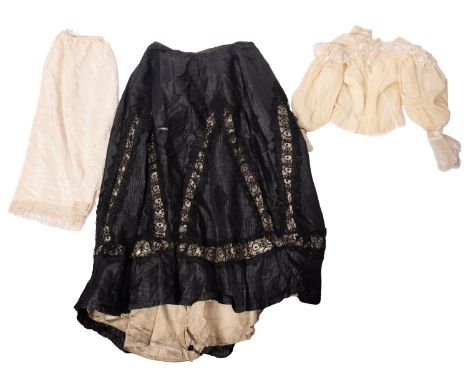 An Edwardian black silk and lace skirt, together with a white cotton and lacework blouse, a yellow cotton embroidered jacket 