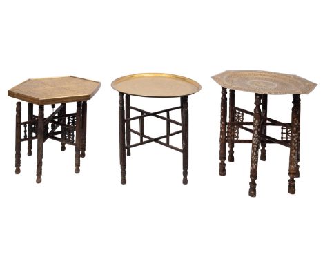 An Indian brass octagonal tiffin table with allover stylised foliate decoration 67cm wide, on mother of pearl inlaid folding 