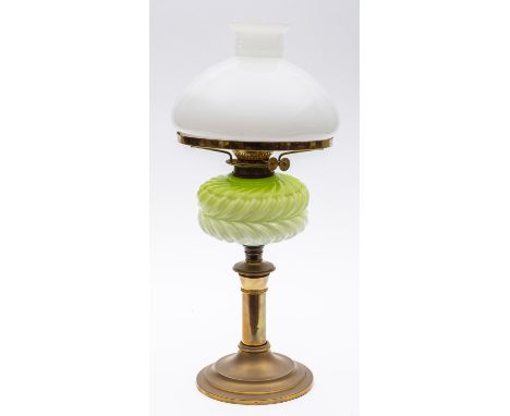 An Edwardian glass oil lamp with opaque glass shade, circular opaque green and white foliate oil font, on brass column and ci
