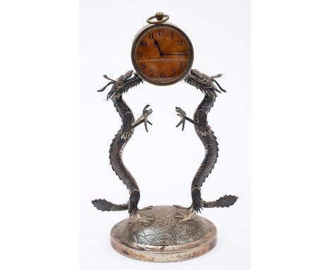 An early 20th century Chinese Export silver stand by Win Nam & Co, Hong Kong, 1875-1920,  with two dragon supports in standin
