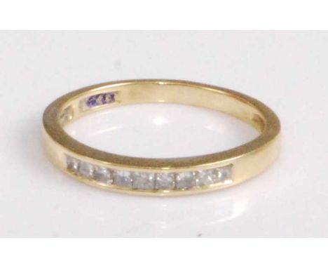 An 18ct gold diamond half eternity ring, arranged as nine channel set small Princess cut diamonds, 2.3g, size M/N