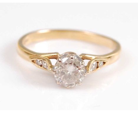 An 18ct yellow and white gold diamond single stone ring, featuring a round brilliant cut diamond in an eight-claw setting, wi